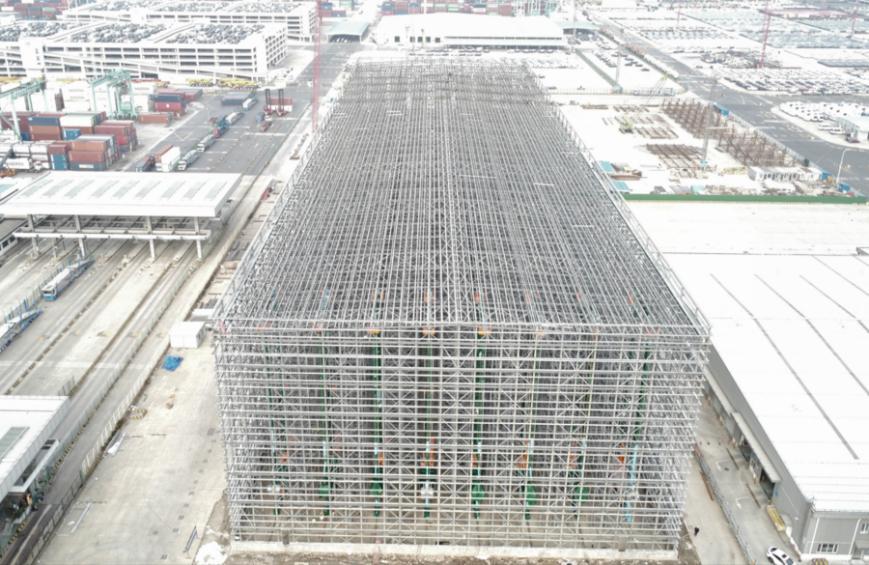国内首个全自动货架式商品汽车中转仓库项目主体工程交工开云电竞验收(图1)